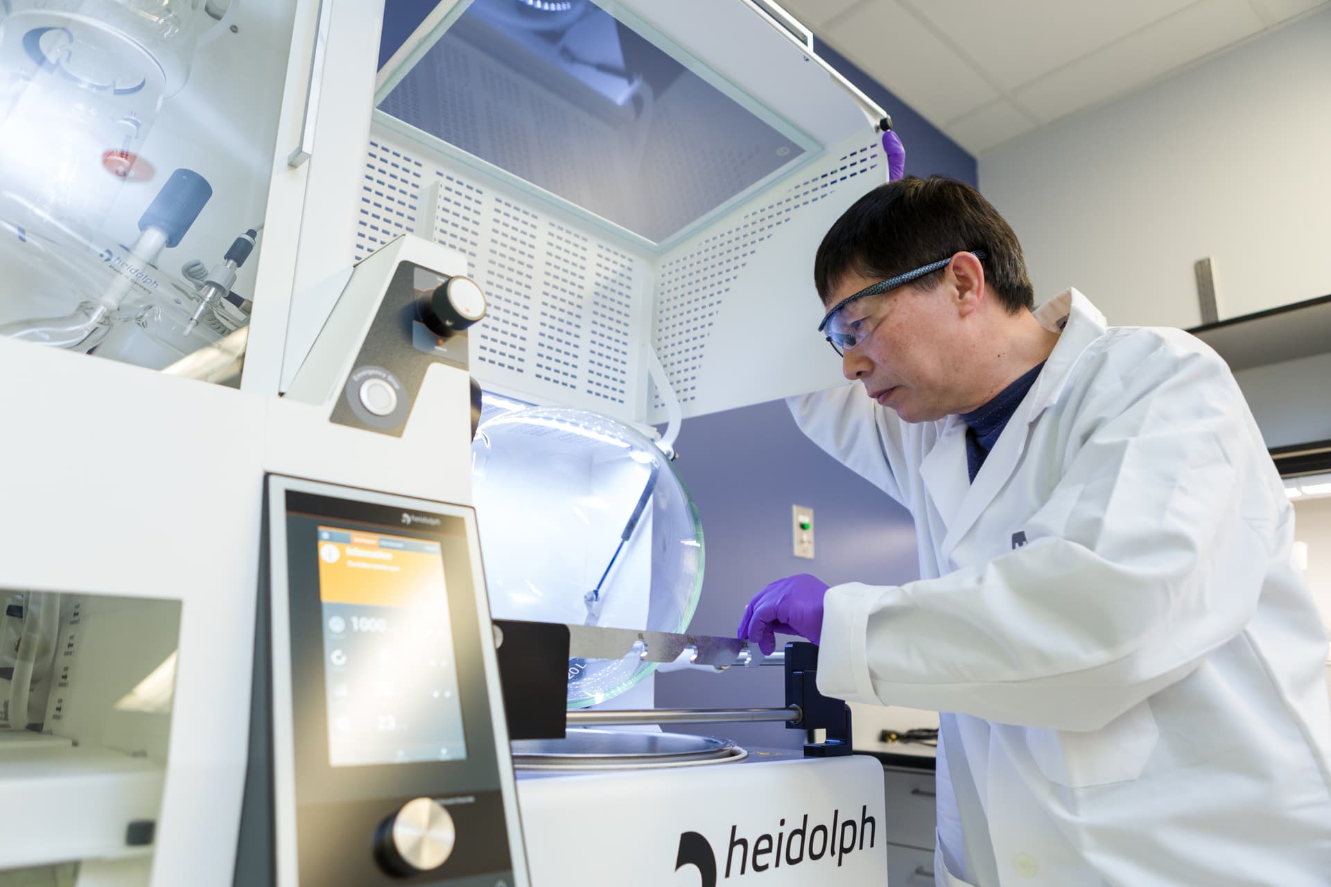 Scientist operating a rotary evaporator in a process chemistry laboratory