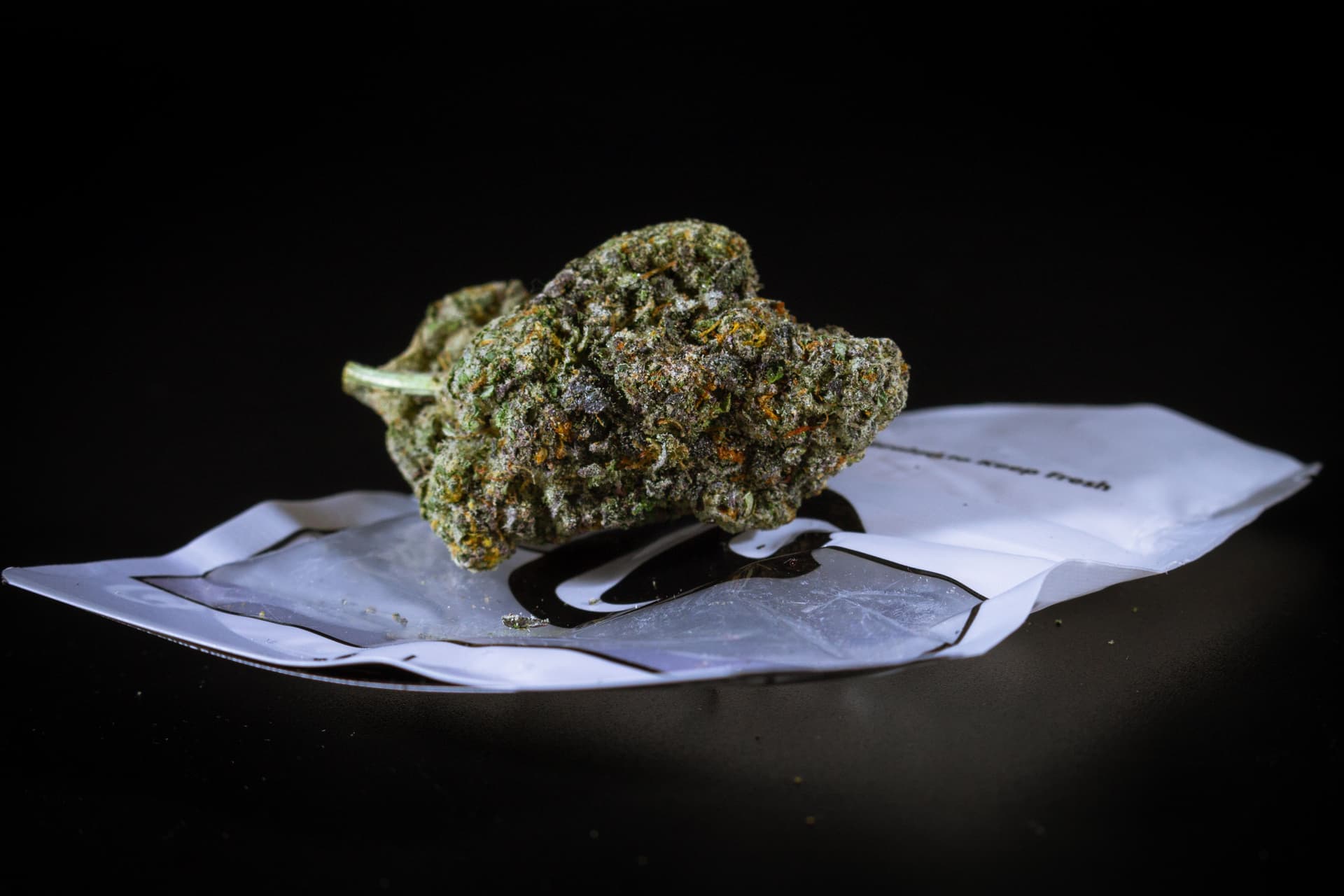 Detailed macro of dense cannabis flower and its surface trichomes
